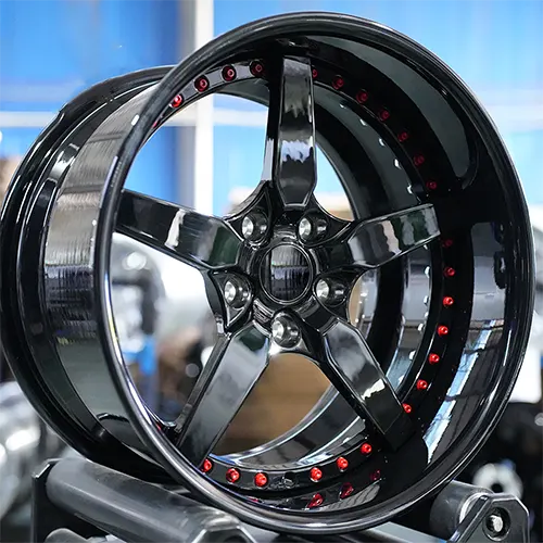 Angled Camaro forged wheel showing red rim bolts and deep lip