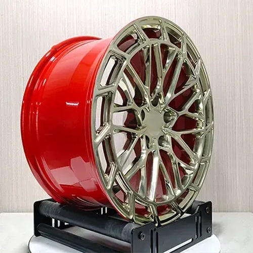 Three-quarter view of BMW F10 forged wheel showing gold face and candy red barrel