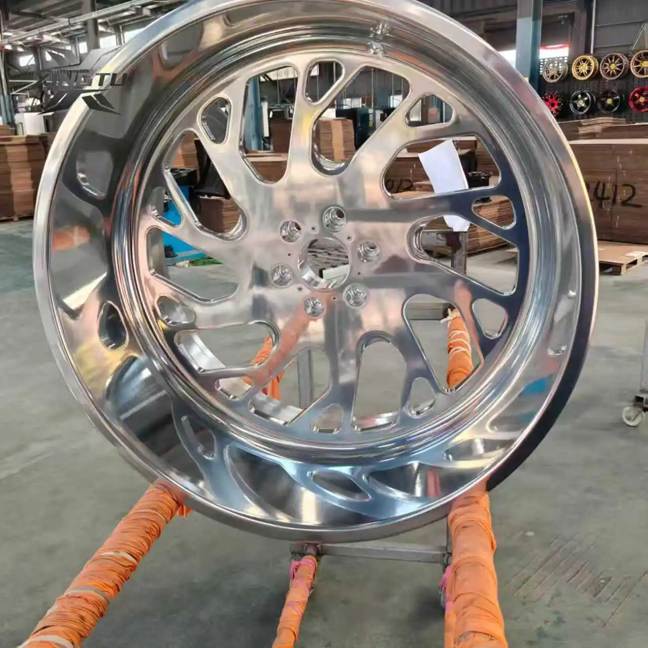 Close-up of forged truck wheel with CNC-machined openings and mirror-polished finish