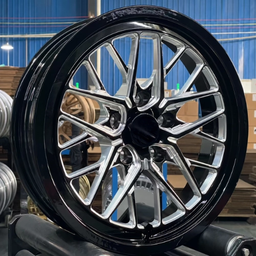 Close-up of black and silver multi-spoke drag racing wheel with machined geometric details