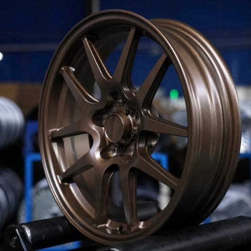Three-quarter view of Camaro skinny front wheel showing narrow barrel and bronze finish