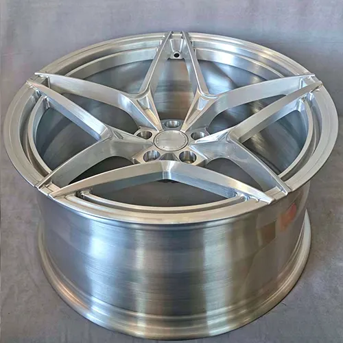 Raw brushed aluminum forged wheel showing CNC-machined spoke details and barrel depth