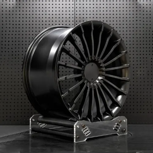 Three-quarter view of matte black Tesla forged wheel showing radial spokes and deep barrel