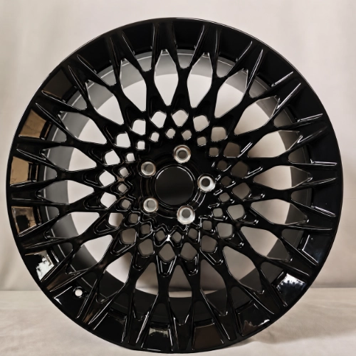Front view of gloss black forged wheel showing detailed geometric mesh openings