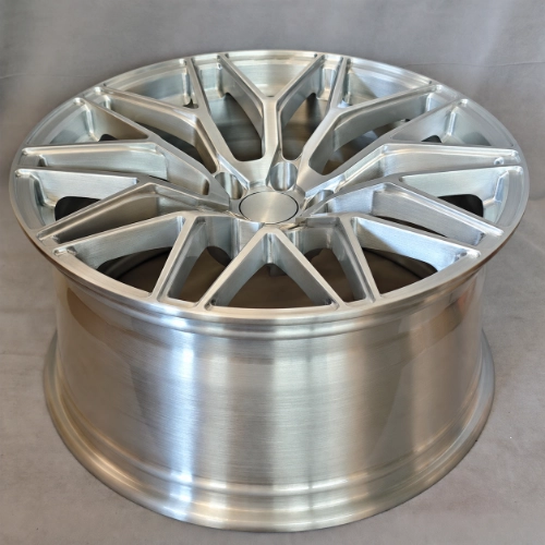 Angled top view of brushed silver forged Mustang wheel with wide rim and Y-spoke face