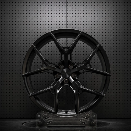 Angled studio view of black 22-inch forged wheel showing spoke depth and barrel