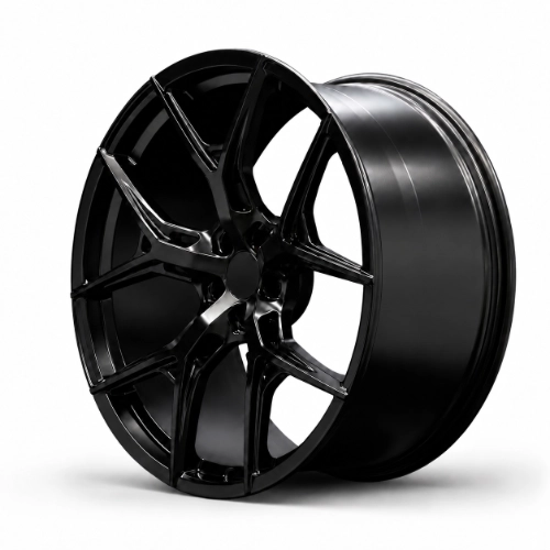 Matte black five-spoke forged wheel displayed at an angle against dark studio background