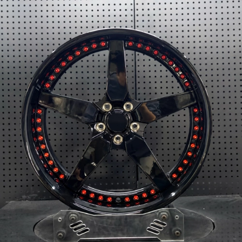Front view of Buick Grand National forged wheel with red perimeter bolts and black five-spoke center