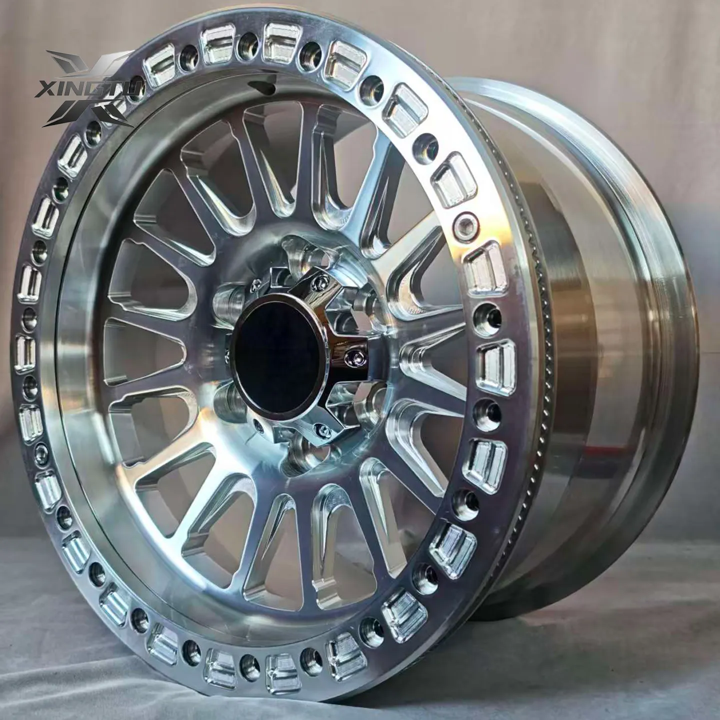 Angled view of raw aluminum forged wheel showing machined spokes and perimeter ring bolts