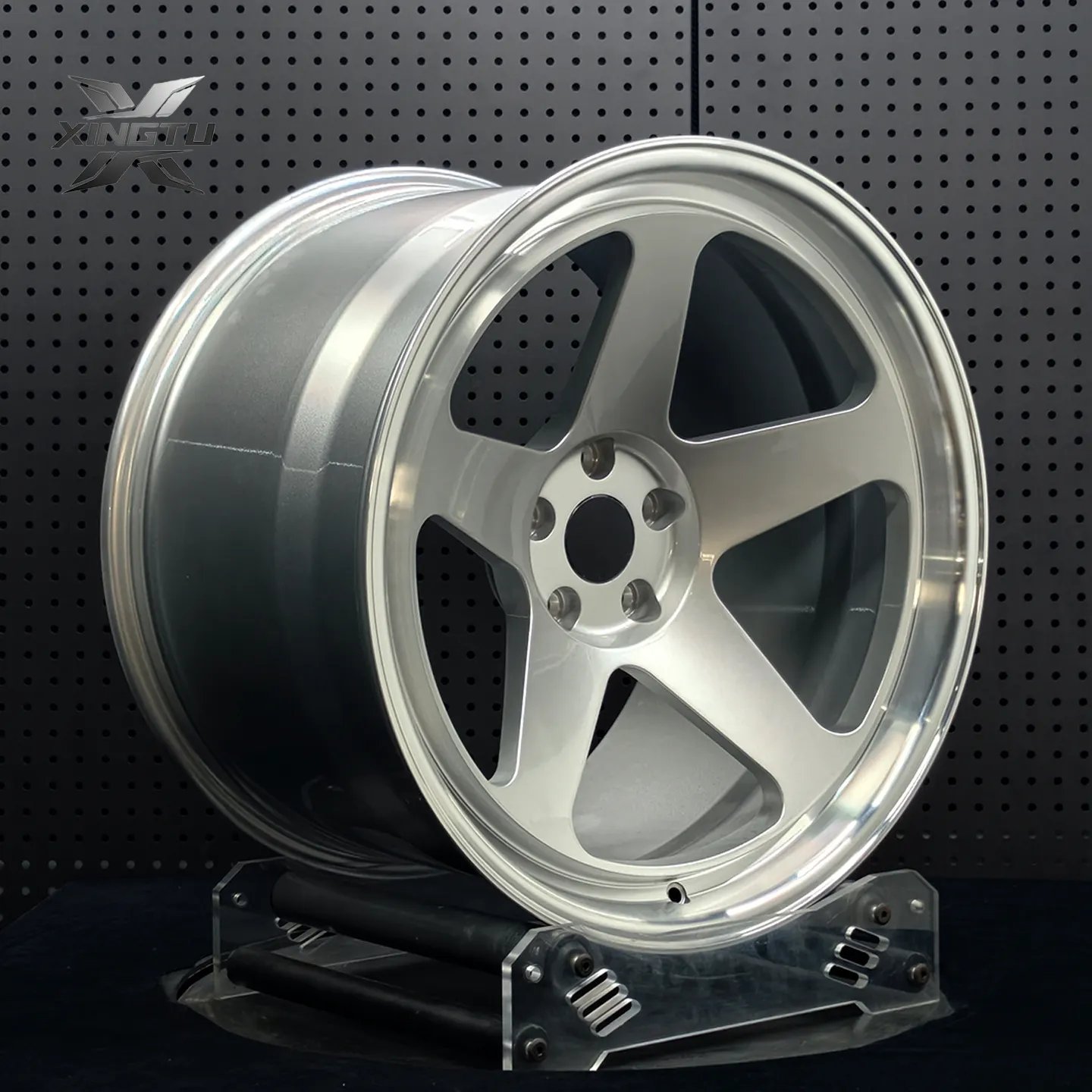 Angled view of silver five-spoke forged wheel with stepped polished outer lip