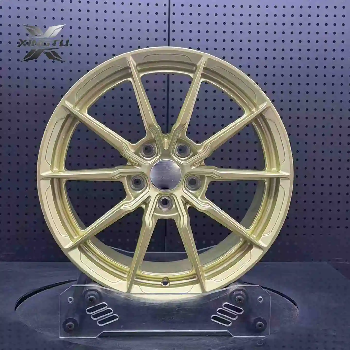 Front-facing gloss platinum gold forged wheel with sculpted split-spoke pattern