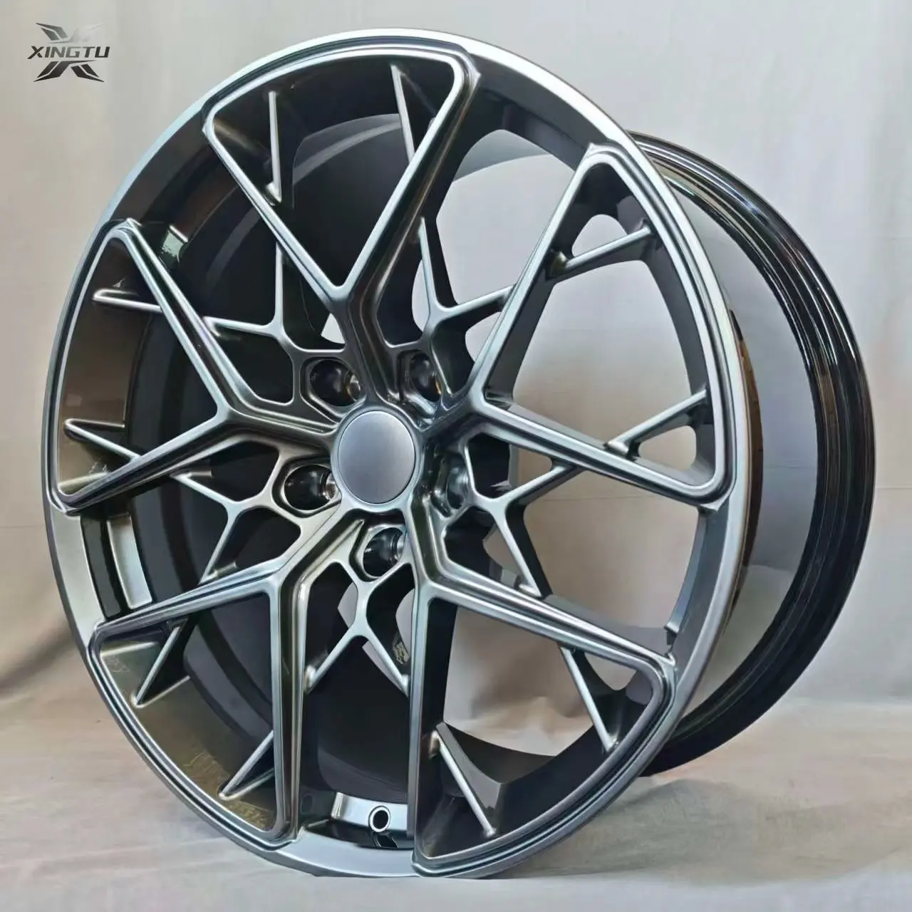 Close-up of gloss black forged wheel with intersecting spokes
